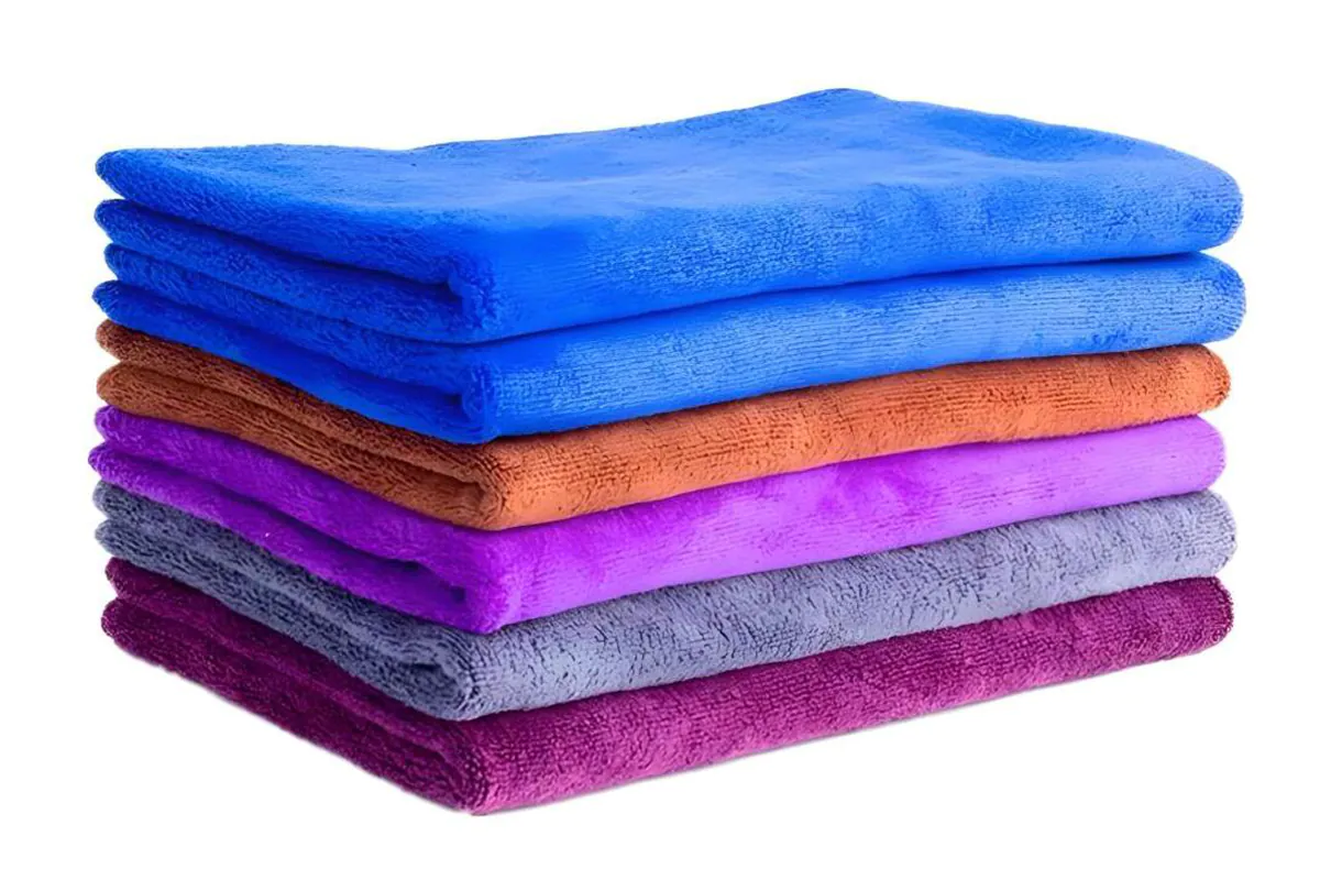 Close-up of a buyer inspecting the quality of microfiber towels